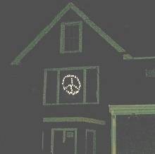 lighted peace symbol in window